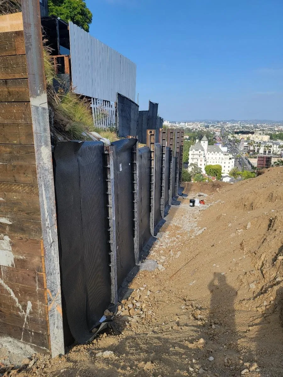 A below-grade wall with waterproofing materials
