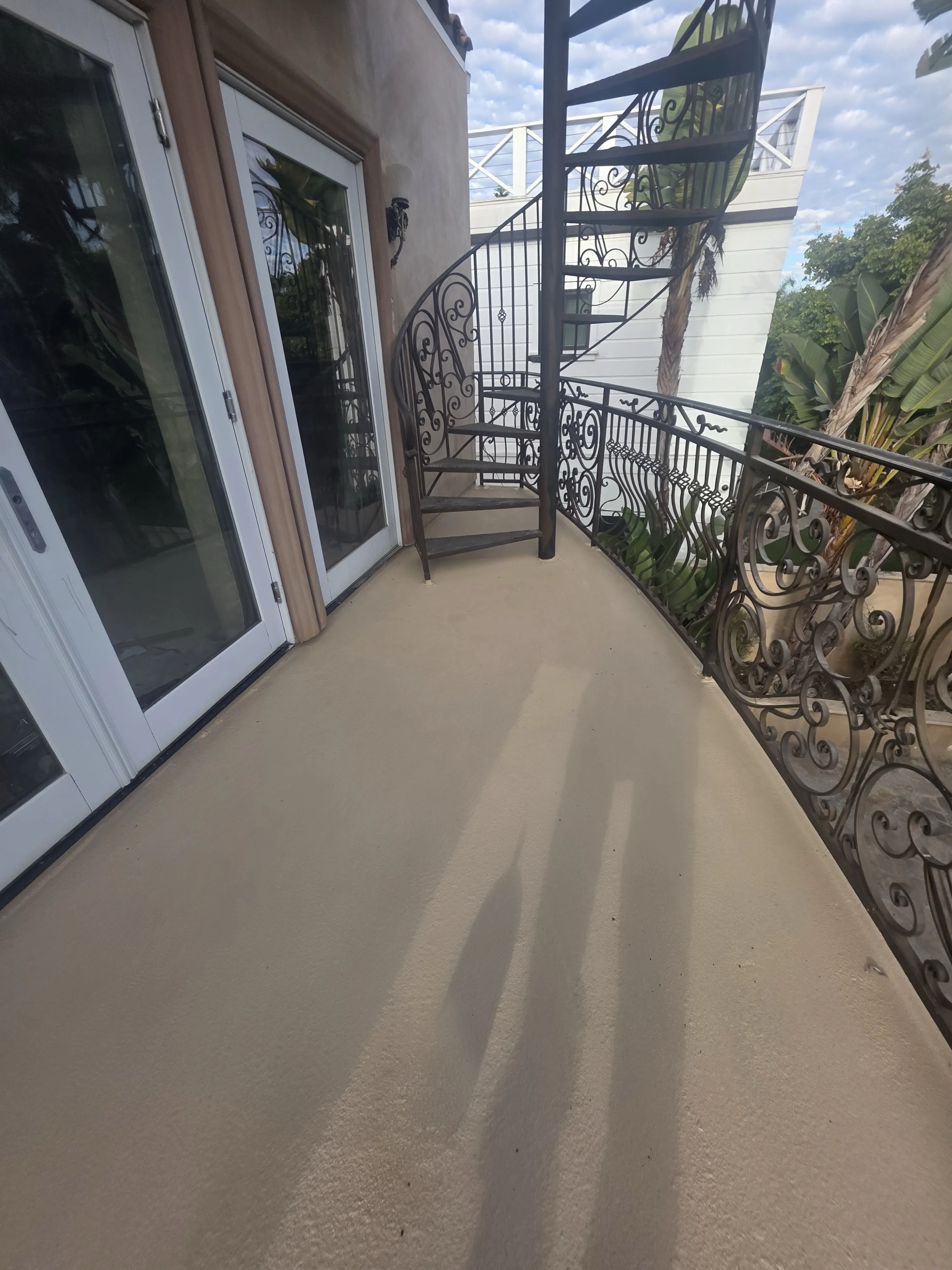 A luxury hillside home in the Hollywood Hills featuring a newly restored and waterproofed circular balcony with panoramic views